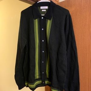 Black button up sweater with green stripes.